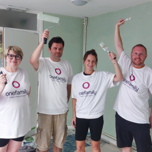 Sara, Tom, Gemma and Olly holding up paintbrushes